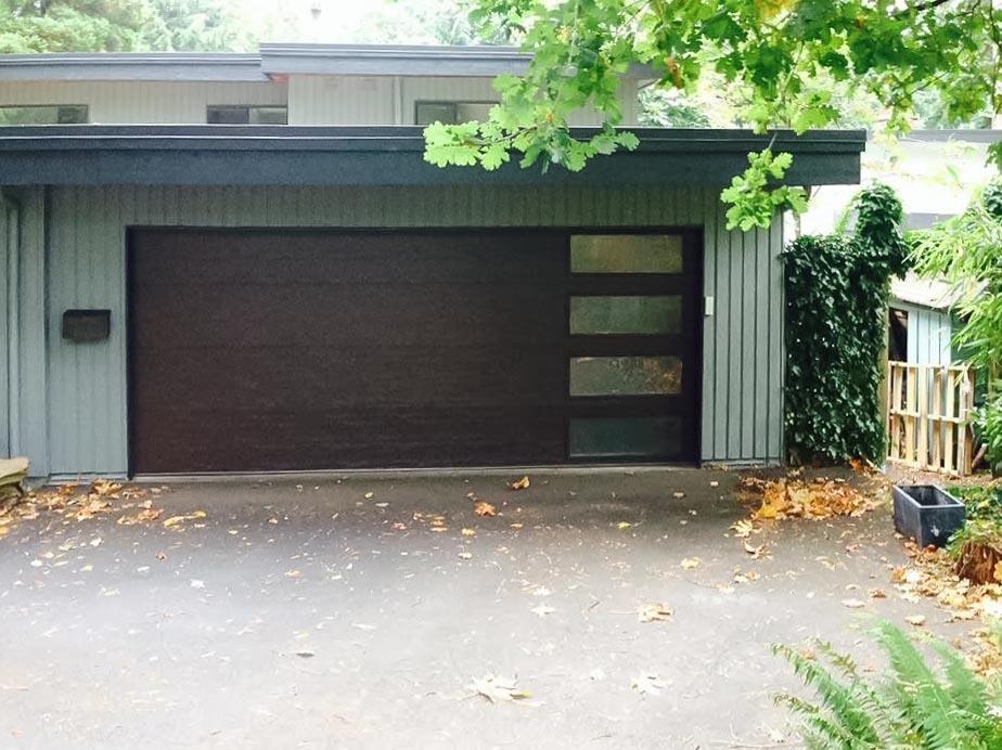 Mundo - Flush Panel Steel with a Natural Wood-Grain Texture Garage Door and Vertical Windows