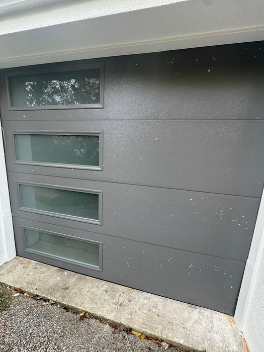 Mundo - Flush Panel Steel with a Natural Wood-Grain Texture Garage Door and Vertical Windows